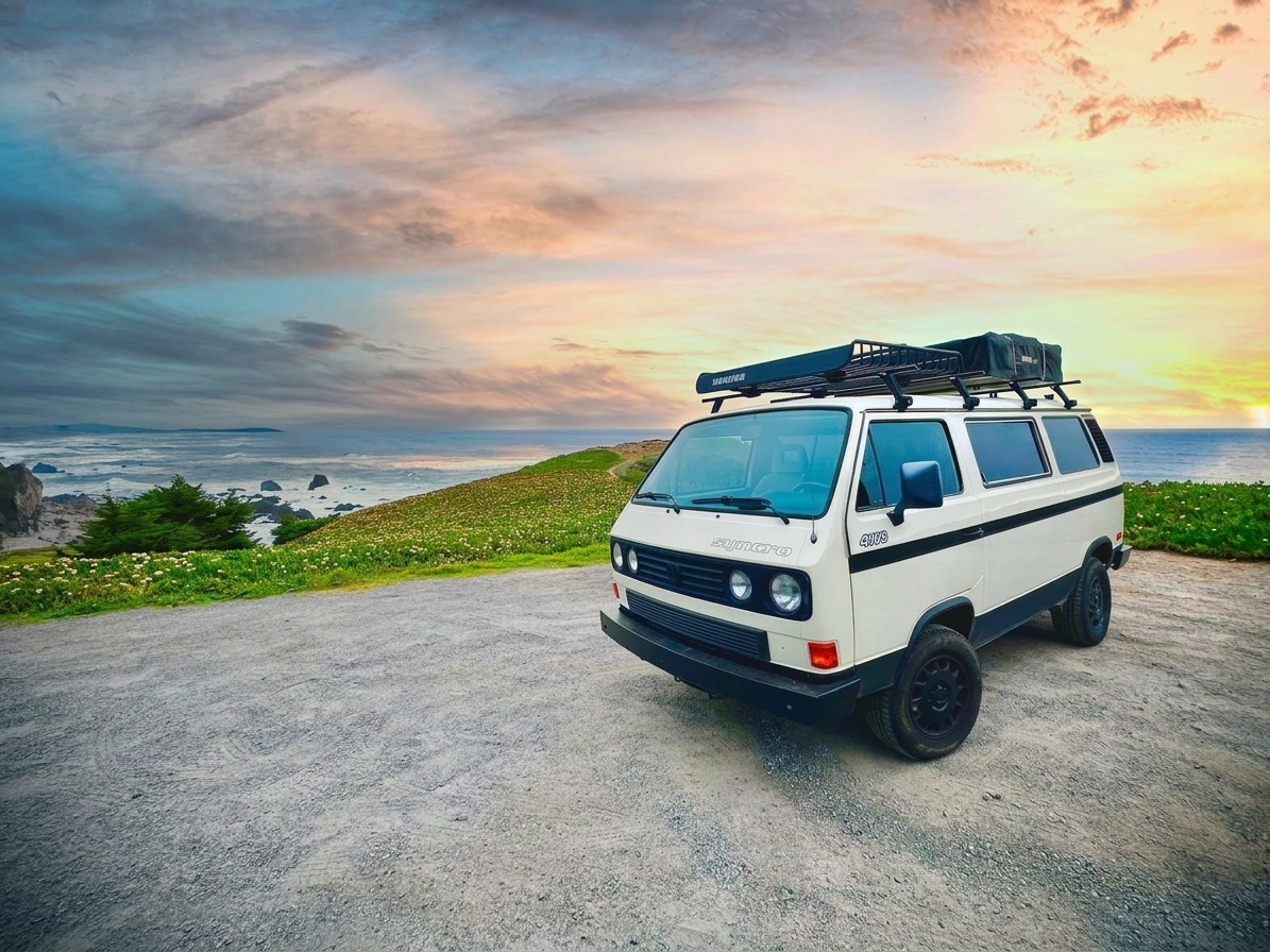 White 1987 VW Vanagon Syncro on a coastal bluff overlooking the ocean